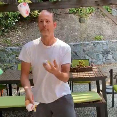 Ahituv juggles outside and Fraser juggles in his kitchen.