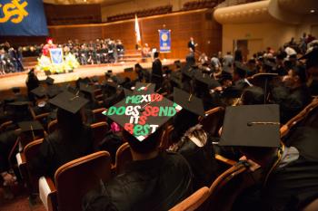 graduate with slogan on hat: "Mexico does send its best"