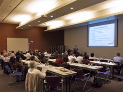 course participants in classroom watch lecturer and screen